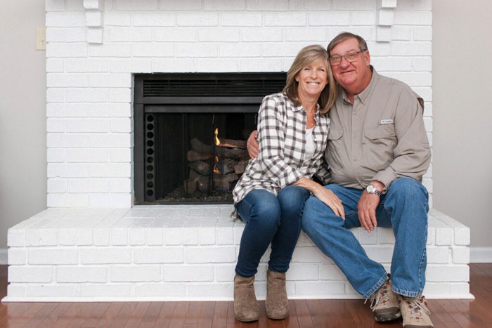 Dallas and Katherine Peebles sitting by the fireplace